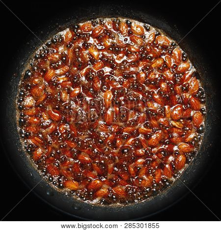 roasted almonds with cinnamon sugar cooking process, top view close-up