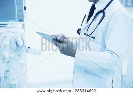 Doctor With Modern Equipment In The Hospital,doctor Using Digital Tablet Against Equipment,equipment