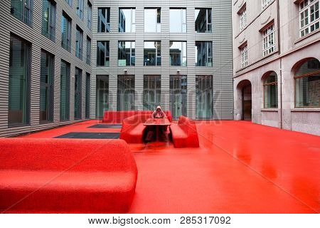 St Gallen, Switzerland - April 17: Red Floor, Red Benches And A Red Hood Man On April 17, 2015 In Ro