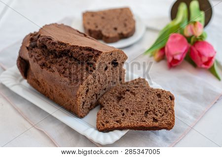 Home Made Chocolate Cake With Tulips On An Easter Table