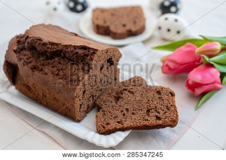 Home Made Chocolate Cake With Tulips On An Easter Table