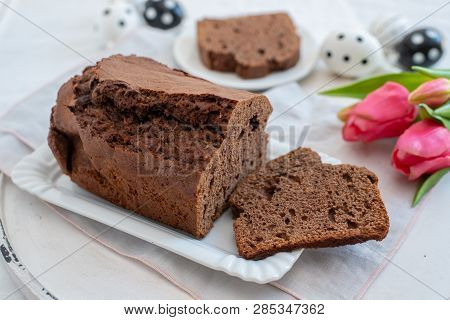 Home Made Chocolate Cake With Tulips On An Easter Table