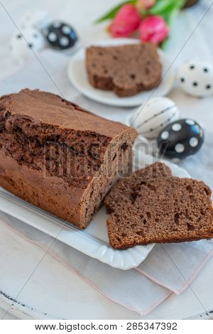 Home Made Chocolate Cake With Tulips On An Easter Table