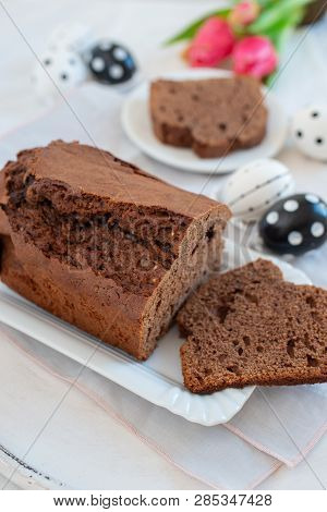Home Made Chocolate Cake With Tulips On An Easter Table