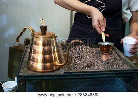 Process Of Making Coffee In Copper Jezva On Stones. Cooking Traditional Turkish Coffee In Pot, Selec