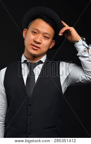 Photo Of An Asian Man, He Raises His Hat By Congratulating