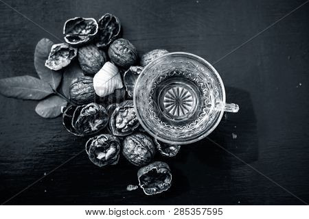 Close Up Of Herbal Organic Tea Of Wall Nut Or Walnut Tea In A Transparent Glass Cup With Raw Wall Nu