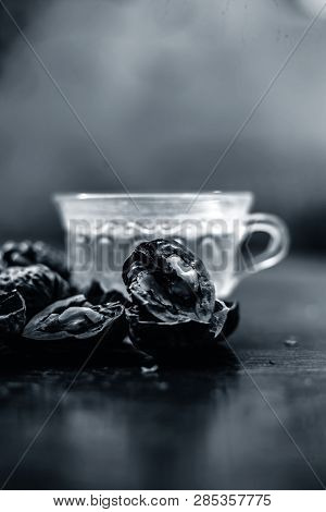 Close Up Of Herbal Organic Tea Of Wall Nut Or Walnut Tea In A Transparent Glass Cup With Raw Wall Nu