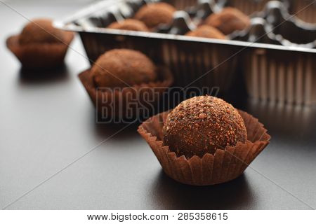 Chocolate Sweet Pralines Over Black Darkmood Background