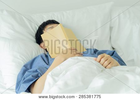 Asian Handsome Man Read Books While Sleeping. Man Book Cover Drowsiness Causes Sleep.the Concept Of 