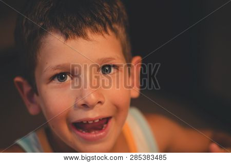 Portrait Of A Boy With Blue Eyes Looking Surprised