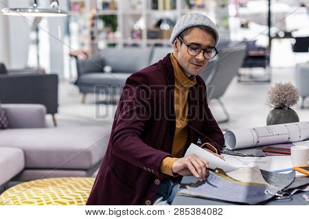 Young Fancy Male Design Department Worker Checking Clothing Materials