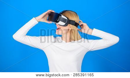 Happy Young Woman Wearing Virtual Reality Goggles Watching Movies Or Playing Video Games. Person Wit