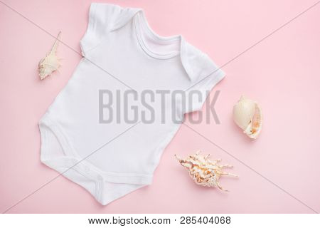 Mockup Flat Lay White Baby Bodysuit Shirt On A Pink Background With A Nautical Theme, Shells And The
