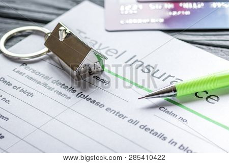 Traveling Concept With Insurance Application On Wooden Table