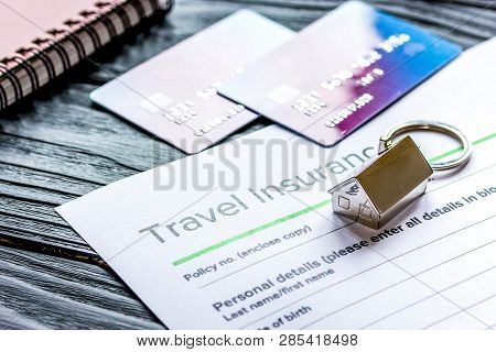 Travel Preparation Concept With Insurance And Cards On Wooden Table