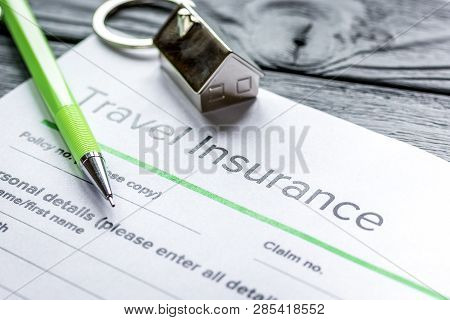 Traveling Concept With Insurance Application On Wooden Table
