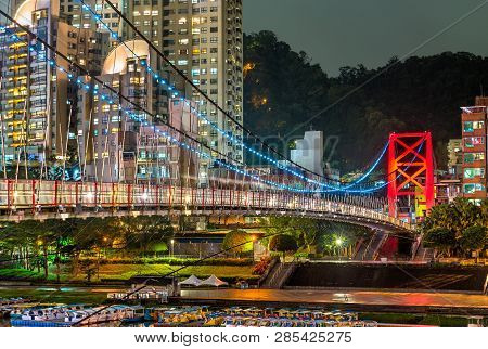 Bitan Suspension Bridge Across The Xindian River At Night. New Taipei City, Taiwan