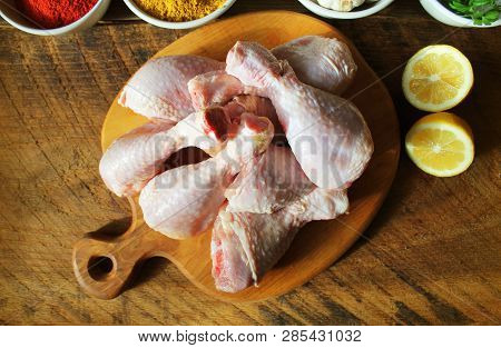 Raw Uncooked Chicken Legs, Drumsticks On Cutting Board, Meat With Ingredients For Cooking