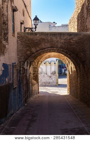 Old City With Its Typical Narrow Street, Lined By Houses And A Wall On The Other Side. Undepass With
