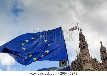 E.u. Flag Flying In Front Of Union Ack Flag At Houses Of Parliament London