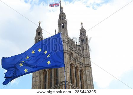 E.u. Flag Flying In Front Of Union Ack Flag At Houses Of Parliament London