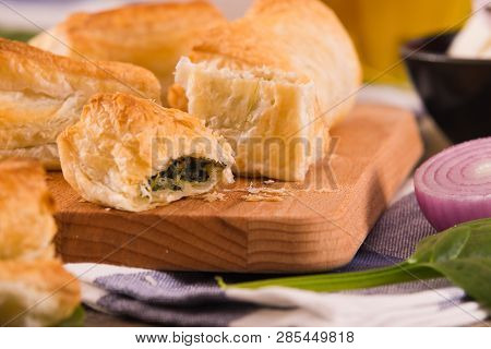 Spinach Puffs With Feta Cheese On Cuttingboard.