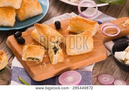 Spinach Puffs With Feta Cheese On Cuttingboard.