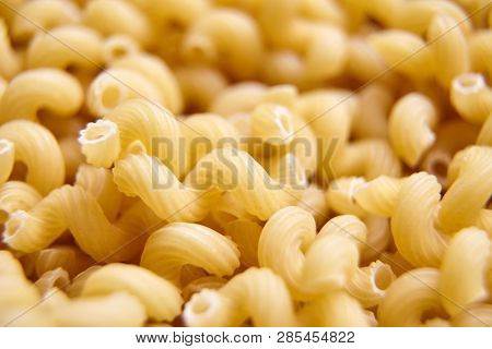 Heap Of Uncooked Cavatappi Italian Pasta . Closeup, Selective Focus