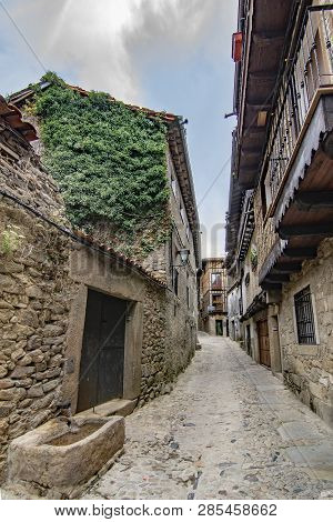 Alberca, Salamanca, Spain; June 2017: view of the fountain and buildings of the medieval village of La Alberca in province of Salamanca