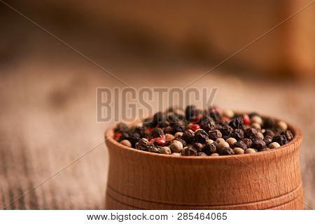 Bowl Of Various Pepper Peppercorns Seeds Mix On Table Rastic Style Background