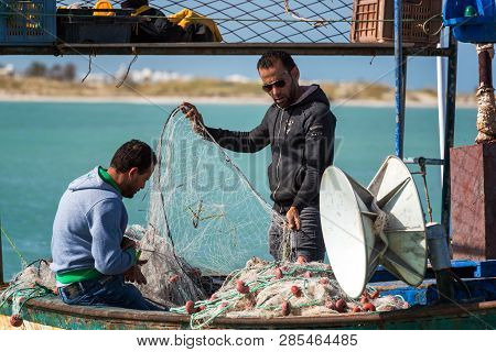 Djerba, Tunisia - April 16: Fishermen Untangling A Net In Djerba, Tunisia On April 16, 2018