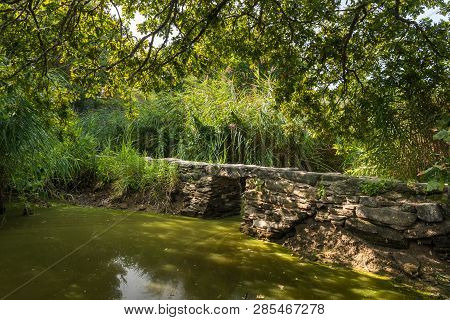 The Small Roman Footbridge Pont De Gras Near Saint-lyphard (france) On A Sunny Day In Summer