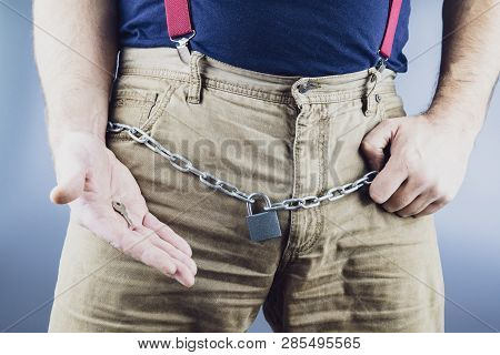 In The Hands Of A Man The Key To The Lock Hanging On The Chain, The Chain Around The Waist At The Gr