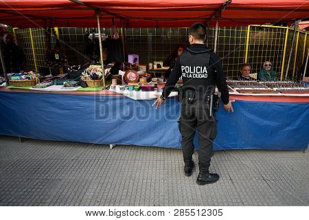 Buenos Aires, Argentina - 24 Jun, 2017: A Policeman Talking With Seller At The Souvenir Shop In Pale
