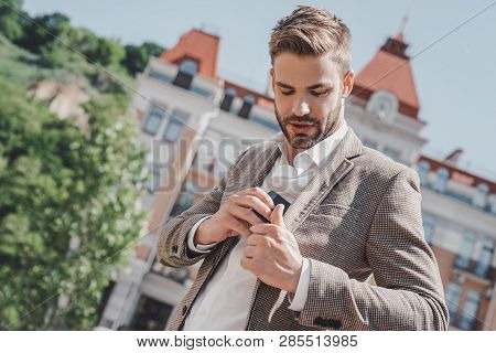 Be Undeniably Good. Serious Brown-haired Man Standing In The Park In The Morning. He Is Going To Wor