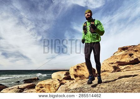 A Man Engaged In Running. Athlete Runs Along The Seashore On A Sunny Day. Trail Running. Mangystau P