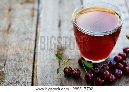 Homemade Cherry Juice In Glass With Freshcherry On Wooden Table. Fresh Fruit Drink