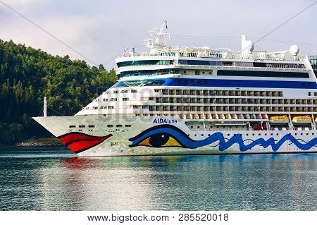 Olden, Norway - August 1, 2018: Aidaluna Cruise Ship In Norwegian Fjords And Summer Mountain Landsca