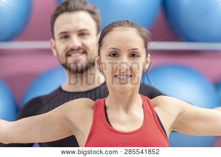 Portrait Of A Fit Couple In A Gym. Slective Focus On The Woman With Braces.