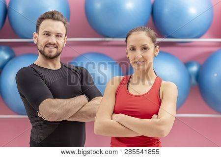 Portrait Of A Fit Couple In A Gym. Slective Focus On The Woman With Braces.