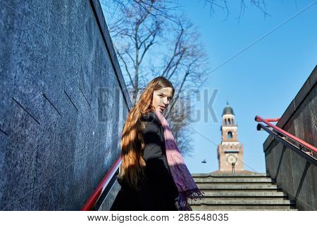 Girl Climbing The Exit Strairs From Cairoli Milan Metro Station In Italy While Looking Back To The C