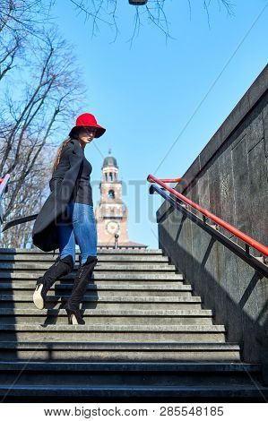 Girl Climbing The Exit Strairs From Cairoli Milan Metro Station In Italy While Looking Back To The C