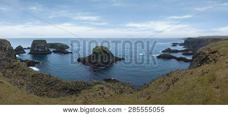 Iceland Landscape Panorama Of Coastline With Many Cliffs At Overcast Day.