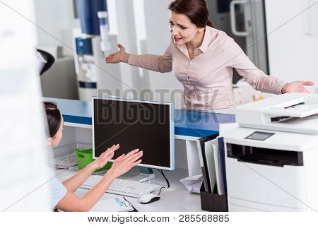 Stressed Patient Talking To Nurse In Clinic