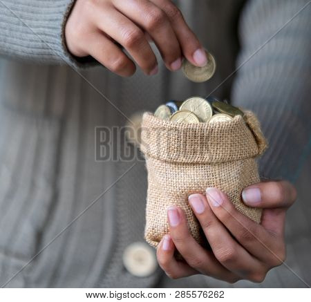 Saving Money Or Coins In A Sack Holding In A Young Female Hand For Brighter Future Education.