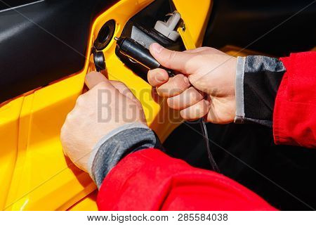 Hands Inserts The Plug Into The 12v Socket From The Atv 4wd Quad Bike Cigarette Lighter