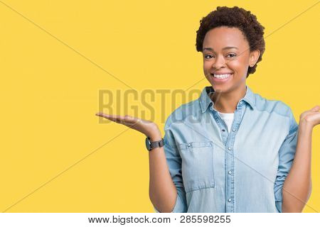 Young beautiful african american woman over isolated background Smiling showing both hands open palms, presenting and advertising comparison and balance