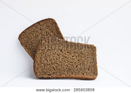 Two Slices Of Dark Rye Bread. Rough Unleavened Bread.