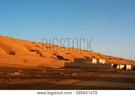 Residential Building Under The Desert Dunes Wahiba Sands At Sunset (oman)